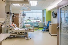 an empty hospital room with medical equipment in it