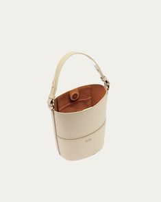 Our darling Bucket Bag is a quintessential piece for every warmer weather wardrobe. Dare we say it’s the ideal home for your phone, keys, lip balm, and favorite pair of sunnies this season (and beyond)? Classic Beige Bucket Bag For On-the-go, Cream Bucket Bag With Removable Pouch For On-the-go, Handheld Bucket Bag With Dust Bag, Everyday Handheld Bucket Bag With Detachable Strap, Modern Handheld Bucket Bag For Travel, Cream Bucket Bag For Everyday Use, Everyday Rectangular Bucket Bag With Mobile Phone Bag, Chic Everyday Bucket Bag With Mobile Phone Bag, Modern Handheld Bucket Bag With Dust Bag