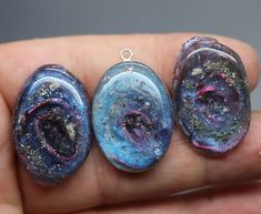 "If you are searching for a truly unique and breathtaking memorial gift, look no further than our milky way pendants! These cremation galaxy necklaces are handcrafted for you with the ashes you provide. Each swirling, shimmery galaxy is set in a 18x25mm oval sterling silver pendant and hangs from your choice of sterling silver chain. These galactic necklaces are built in layers to give them as much depth as possible. In the comments box, please note how defined you would like the \"swirl\" to be Handmade Cosmic Jewelry For Gifts, Handmade Cosmic Style Jewelry For Gifts, Cosmic Style Handmade Jewelry As A Gift, Celestial Resin Jewelry As A Gift, Celestial Resin Jewelry As Gift, Celestial Resin Jewelry For Gifts, Celestial Style Resin Jewelry For Gifts, Thumbprint Jewelry, Ashes Jewelry Cremation