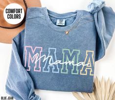 You will love this Comfort Colors sweatshirt for your Mama.  This crewneck sweatshirt has a colorful design on the front of the sweatshirt that says Mama.  This minimalist sweater will be perfect for your Mama's Birthday, Mama's Christmas or Mom's Mother's Day.  Your Mama will love wearing this trendy sweater this fall and winter season. Attn: I am the original creator of this design.  If you see this design for sale anywhere else, it has been stolen.   Luxurious comfort and style are what this Multicolor Crew Neck Sweatshirt For Loungewear, Multicolor Letter Print Relaxed Fit Sweatshirt, Multicolor Letter Print Sweatshirt Relaxed Fit, Casual Cotton Sweatshirt For Birthday, Trendy Letter Print Sweatshirt For Mother's Day, Fall Letter Print Multicolor Sweatshirt, Casual Long Sleeve Birthday Sweatshirt, Mother's Day Graphic Print Crew Neck Sweatshirt, Casual Slogan Sweatshirt For Mother's Day