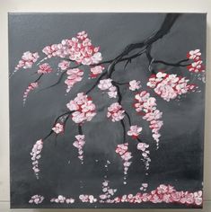 a painting of pink flowers on a black and gray background with white trim around the edges