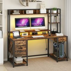 a computer desk with two monitors and a keyboard on it in front of a bookshelf