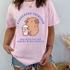 Get ready to be OBSESSED with your new Passenger Princess Capybara Shirt. It's the cutest and most trendy way to emit all those important passenger princess ~vibes~! This is the perfect answer to: "I want preppy stuff"! * Q U I C K * F A C T S * ★ Comfort Colors garment-dyed t-shirt  ★ Medium fabric - all shirts feature pre-shrunk cotton ★ Wash and dry normally (on cool for best results) * S I Z I N G * ★  Models are wearing size L-XL  ★ Sizing is unisex so runs like men's, though not overly large ★ Most women find their typical size works best, since they are meant to fit a touch loose ★ Please see size guide in photos for more info  ★ If you are looking for an oversized tee or baggy fit, it is recommended to go at 1-2 sizes over your normal size. Comfortcolors tees offers a roomy fit, ho Iced Coffee Shirt, Capybara Shirt, Coquette Clothes, Passenger Princess, Princess Vibes, Princess Shirt, Preppy Stuff, Baggy Clothes, Coffee Shirt