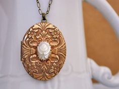 Beautiful vintage American made 70s brass locket decorated with hand carved shell flower cab in center. Limited stock vintage American made 70s brass locket, other lockets shown in last picture are listed separately in my shop here, https://www.etsy.com/shop/junesnight?ref=condensed_trust_header_title_sold&section_id=6510070 Measurement: Lockets is about 1.7 inch (43mm) in length and 1.35 (33mm) wide, it hangs on 18 inch antiqued brass chain with lobster clasp as shown or simply choose a pre Vintage Handmade Gold Locket Necklace, Vintage Flower Pendant Locket Necklace For Wedding, Vintage Cameo Locket Necklace For Wedding, Vintage Gold Brass Locket Necklace, Ornate Engraved Locket Necklace Vintage Collection, Vintage Brass Flower Jewelry, Vintage Bronze Locket Necklace In Brass, Ornate Brass Locket Jewelry, Vintage Bronze Brass Locket Necklace