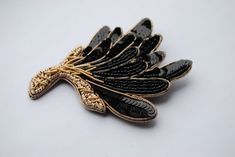 "The beaded black and gold brooch shaped like a gorgeous wildflower and decorated with sequin embroidery. You can pin this statement brooch to your hat or wear it to affix a scarf. You can even use this embroidered flower brooch as a stylish hair accessory. You can wear your sequin brooch in hundreds of ways, your only limit is your imagination! Also, it would be a beautiful gift for a mother or wife, who loves beadwork jewelry.  Materials: chenille, seed beads, crystals, spun gold. Size: 2.75\" Handmade Elegant Black Brooches, Elegant Gold Embellished Brooches, Elegant Embellished Evening Brooch, Sequin Brooch, Beadwork Jewelry, Statement Brooch, Jewelry Materials, Embroidered Brooch, Sequin Embroidery