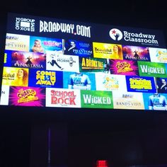 a big screen with many different movies on it