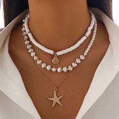 Boho Starfish Conch Pendant 3Pcs/Set - Elegant White Imitation Pearl Chain Necklace | Y2K Summer Beach Jewelry for Women Embrace the essence of summer with the Boho Starfish Conch Pendant 3Pcs/Set Necklace, a stunning collection perfect for beach lovers and mermaid souls. This elegant set features delicate white imitation pearls, combined with charming starfish and conch pendants, capturing the spirit of Y2K and bohemian style. Crafted with care, this polymer clay jewelry set is designed to comp Trendy Star Charm Jewelry For Summer, Trendy Summer Jewelry With Star Charm, White Layered Necklace For Beach, White Layered Necklace For Beach In Summer, White Star Necklace For Beach, Trendy White Star Necklace, White Starfish Necklace For Summer, Necklace Y2k, Summer Beach Jewelry