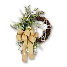 a wreath with flowers and a cross on it