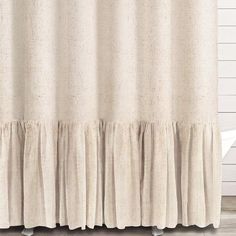 a beige shower curtain with ruffled edges