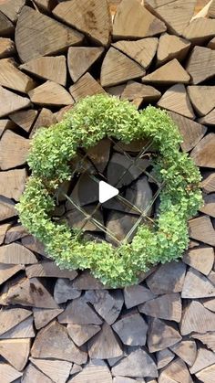 a pile of wood with a wreath on top