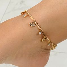 The bee charms, elegantly spaced along the anklet bracelet, add a touch of whimsy and nature's allure. The charm of these buzzing creatures is amplified by their symbolism, representing diligence, teamwork, and the importance of appreciating the small wonders in life. The bees' presence on the anklet bracelet creates a delightful and unique accessory that is meaningful and fashionable. PRODUCT DESCRIPTION Multicolor Cubic Zirconia Stone Anklet Material: -Gold Filled - Anklet Lenght: 10 inches - Gold Dangle Anklets As Gift, Gold Dangle Anklets For Gift, Elegant Gold Dangle Anklets, Cuban Anklet, Stone Anklet, Cute Anklets, Charm Anklet, Pretty Jewelry Necklaces, Crystal Anklet