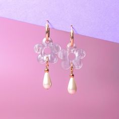 The Daisy Pearl Drops are elegant floral earrings that add a touch of class and polish to any outfit. Perfect for a fancy affair (wedding! date night!) or any occasion when you want to impress and glimmer! Hand-made in studio using beautiful marbled acrylic and glass pearls.  The drops hang from 18mm, 14 karat, gold-filled hoops and are removable so you can wear the hoops on their own—two earrings in one, perfect for travel! Uses 14 karat gold-filled hoops which are tarnish resistant and hypoall Elegant Teardrop Earrings With Flower Charm, Elegant Bridal Dangle Earrings With Flower Charm, Feminine Teardrop Earrings For Anniversary, Chic Flower Jewelry For Weddings, Chic Wedding Jewelry With Flower Charm, Chic Floral Wedding Jewelry, Feminine Flower Shaped Pearl Drop Earrings, Elegant Clear Flower Shaped Earrings, Feminine Flower Drop Earrings With Pearl Drop