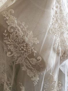 Ivory Alencon Lace Fabric Floral Pearl Beaded Sequined Wedding Lace Fabric 55 Inches Wide 1 Yard Embellished Lace Embroidered Fabric For Wedding, Elegant Pearl Embroidered Lace For Wedding, Elegant Wedding Lace With Pearl Embroidery, Fitted Lace Bridal Belt For Ceremony, White Lace Back Wedding Dress, White Fitted Bridal Belt For Ceremony, White Wedding Dress With Lace Back, Elegant Wedding Dress With Lace Work, Cream Tulle Fabric With Intricate Embroidery For Wedding