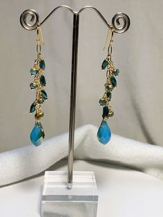 Beautiful fire polished crystal beaded earrings in aqua and gold that measure approximately 2.5 inches in length. gold filled ear wires. Gold Czech Glass Beaded Earrings For Party, Gold Long Drop Beaded Earrings With Ear Wire, Handmade Gold Long Drop Crystal Earrings, Gold Czech Glass Beaded Earrings With Faceted Beads, Gold Long Drop Crystal Earrings For Jewelry Making, Gold Czech Glass Earrings For Party, Party Gold Earrings With Czech Glass, Gold Faceted Crystal Earrings For Party, Gold Czech Glass Earrings With Faceted Beads