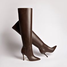 Since the very beginning, the Kate has been a runaway bestseller. So we couldn't help but add a few additional pairs to the mix, now in a super duper thigh-high silhouette. With just enough height to go over the knee, we love wearing these to make a major statement in the boot shape that's forever a favorite. Product Details: Brown Shine kid skin leather Closed pointed toe Pull up boot 3.8 inch stiletto heel Larroudé “L” logo in golden hardware Finely crafted leather sole for support, durability L Logo, Kitten Heel Boots, Platform Flats, Sandal Platform, Trending Boots, Jennifer Fisher, Super Duper, Pumps Flat, Handmade Shoes