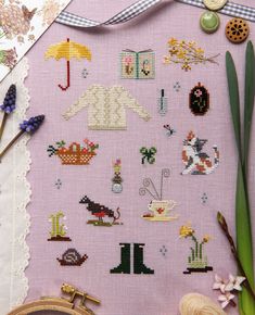 a close up of a cross stitch pattern on a cloth with scissors and other items