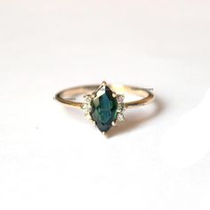 Pretty and simple Teal Sapphire diamond engagement ring. The stones can also be of other shape or kind.Gorgeous Marquise Teal Sapphire Diamond Ring, Stackable Beautiful Ring, Delicate Gemstone Ring, Wedding/Engagement Beautiful Jewelry.Product info:Main gemstone: Teal SapphireShape: Marquise Measurements: approx. 10*5 mmSide stones: white diamondsShape: roundMeasurements: approx. 1.5 mmQuality: I-J color, SI clarity, conflict-freeItem will be resized and shipped within 10 days.ITEM Will BE SHIPP Blue Marquise Engagement Ring, Green Marquise Diamond Ring, Elegant Sapphire Rings For May Birthstone, Sapphire Ring With Accent Stones For May Birthstone, Blue Emerald Rings For Wedding, Sapphire Ring For May Birthstone, Fine Jewelry, Oval Sapphire Ring For May Birthstone Wedding, Dainty Sapphire Gemstone Ring For Wedding, Marquise Gemstone Ring