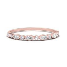 a rose gold wedding band with five diamonds