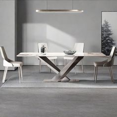 a modern dining table and chairs in a room with grey walls, white flooring and artwork on the wall