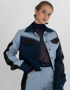 A straight-cut jacket made of denim in light and dark shades, as well as black vegan leather, reaching the waist. It features a shirt collar, button closure, and long sleeves. The jacket is additionally adorned with reflective tape, giving it a stylish and modern look and making you visible in the dark.Product Specifications:Back length: 43 cm / 17 insleeve length: 66 cm / 26 inSeason: Spring/Summer/FallModel height: 170 cm / 67 in, wearing size One sizeComposition: 100% cottonCare: Delicate wash at 30°C. Spin at 600-800 rpm. Do not use the tumble dryer.Avoid chlorine bleach and stain removers. Ironing: medium temperature, STRICTLY from the inside out.About the brand:7/11 Seven Eleven has been working since July 2015. The brand creates qualitative unisex, obscenely feminine, ultrasexual fa Urban Fitted Denim Jacket For Workwear, Trendy Blue Cropped Jacket For Work, Modern Denim Outerwear For Fall, Winter Workwear Blue Denim Jacket, Seven Eleven, Stain Removers, Reflective Tape, Black Vegan, Dark Shades