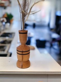 a wooden vase with some flowers in it