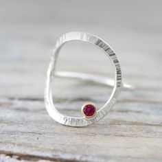 { P r o d u c t } An unusual ring that is forged and textured and set with a ruby. { M a t e r i a l s } - sterling silver ring - 18K gold bezel setting - ruby { D i m e n s i o n s } - 14 gauge wire - 3mm stone { S i z e s } I can make this ring in sizes 3 to 16 (US), including half and quarter sizes; if you are not able to select it from the drop down menu, please leave me a note at checkout with your size(s). {S h i p p i n g } - Canada: We offer free shipping on all orders over CAD $40. - US Forged Ring, Ring With Ruby, Silversmithing Jewelry, Modern Silver Jewelry, Handmade Silver Jewellery, Metalsmithing Jewelry, Handmade Sterling Silver Rings, Unusual Rings, Metal Clay Jewelry