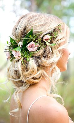 a woman with flowers in her hair wearing a floral headpiece and looking off into the distance