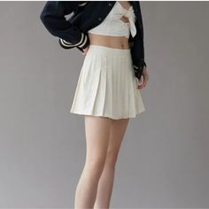 Elevate Your Casual Wardrobe With This Urban Outfitters Linen Pleated Mini Skirt In Ivory. The Skirt Features A Solid Pattern And A Zip Closure For A Minimalist And Collegiate Look. Perfect For Summer, Fall, And Spring, This Skirt Is Made Of A Linen Blend Material That Is Machine Washable For Easy Care. The Skirt Has A Short Length And A Pleated Design With No Pockets For A Streamlined And Preppy Look. It Is A Size Small And Fits Regular Size Types. This Skirt Is Ideal For Casual Occasions And C Casual High Waist Solid Color Tennis Skirt, High Waist Solid Color Tennis Skirt For Spring, White High Waist Skort, White High Waist Solid Color Skort, White High-waist Skort, Spring Mini Skort In Solid Color, White Solid Color Summer Skort, Casual Solid Color Mini Pleated Skirt, Chic Mini Hem Pleated Skirt For Summer