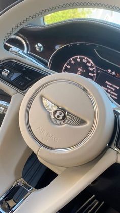 the steering wheel and dashboard of a luxury car