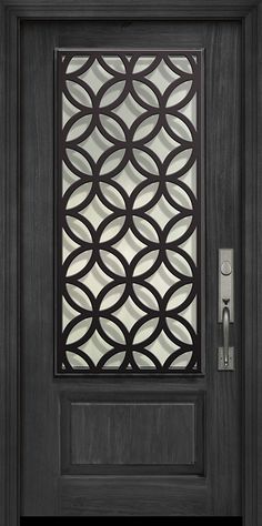 the front door is made from dark wood and has an intricate iron grille design on it