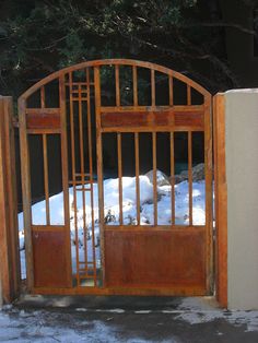 an open gate with snow on the ground