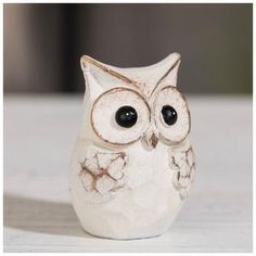 an owl figurine sitting on top of a table