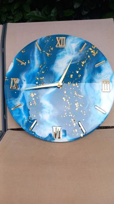 a blue and gold clock sitting on top of a chair