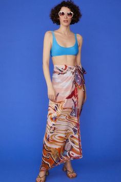 Wrap yourself in luxury with our Multi Tie-Waist Sarong, a versatile piece that exudes tropical elegance. Crafted from a sumptuous blend of cashmere, silk, and cotton, this sarong offers an incredibly soft touch while maintaining a lightweight, airy feel. The vibrant tropical print transports you to paradise, while the contrast hem adds a chic, defined edge. Designed with a flexible tie-waist, this one-size-fits-all sarong is perfect for beach days, poolside lounging, or adding a stylish layer t Summer Silk Printed Bottoms, Versatile Summer Wrap Bottoms, Elegant Silk Sarong For Beach, Elegant Wrap Sarong For Summer, Elegant Summer Wrap Sarong, Elegant Spring Vacation Sarong, Multicolor Silk Sarong For Beach, Silk Sarong For Beach Spring Season, Silk Sarong For Beach