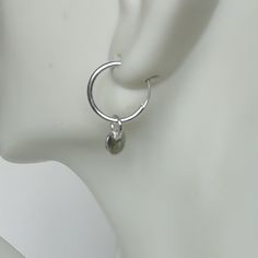 A PAIR of sterling silver hoops. Comes with a detachable tiny and delicate round disc charm. The charm is multipurpose and can be used with a neck or bracelet chain too. Dimension: Hoop- 12x1.2 mm Charm- 5 mm Drop length- 17 mm Price listed is for ONE PAIR These are made of 925 hypoallergenic sterling silver. Most of my pieces come with a 925 stamp. Can be packaged in a gift box. I can include a personal message from you if needed You are welcome to contact me at... bhavnakwintra1956@gmail.com F Minimalist Metal Round Huggie Earrings, Minimalist Round Metal Huggie Earrings, Minimalist Metal Round Cartilage Earrings, Minimalist Round Metal Cartilage Earrings, Modern Nickel Free Round Cartilage Earrings, Modern Nickel-free Round Cartilage Earrings, Minimalist Small Hoop Nickel-free Earrings, Minimalist Metal Small Hoop Huggie Earrings, Minimalist Dangle Hoop Earrings