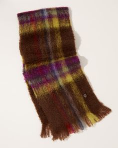 a brown and yellow plaid scarf laying on top of a white table