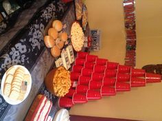 a table topped with lots of food and cups