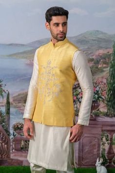 Yellow bundi with floral embroidery using zari, pearl, sequin. Paired with an inner kurta and pant. - Aza Fashions Festive Bandhgala With Chikankari Embroidery For Designer Wear, Unstitched Festive Bandhgala Straight Kurta, Wedding Nehru Jacket With Gota Work For Eid, Eid Wedding Nehru Jacket With Gota Work, Festive Raw Silk Bandhgala With Gota Work, Festival Bandhgala With Gota Work In Raw Silk, Wedding Eid Nehru Jacket With Gota Work, Festive Raw Silk Bandhgala, Designer Nehru Jacket With Gota Work For Eid