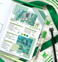 the contents of a planner spread out on a white blanket with green ribbons and markers