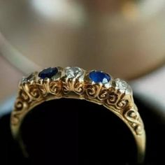 a gold ring with blue and white stones