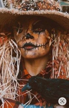 a person in a costume and hat holding a black bird on his shoulder with the caption that reads, halloween is here