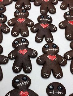 many decorated cookies are arranged in the shape of zombies