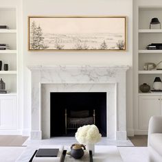 a living room filled with furniture and a fire place in front of a white fireplace