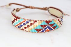 Introducing our adjustable southwestern beaded cuff bracelets! This colorful cuff bracelet is handmade with a southwestern-inspired pattern in cream, dark red, blue, orange, turquoise, and soft yellow.The bracelet is strung on strong beading thread and flexible leather cord with an adjustable closure, making it easy to put on and take off, while also allowing you to customize your fit. It will fit 6-8 inch wrists.Whether you're dressing up for a special occasion or just accenting your everyday s Beading Thread, Orange Turquoise, Beaded Cuff Bracelet, Beaded Cuff, Soft Yellow, Blue Bracelet, Natural Leather, Leather Cord, Dark Red