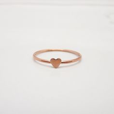 REAL ROSE GOLD FILLED 14/20 I love how this adorable little heart ring turned out and am so happy to share it with you! The dainty band features a polished surface, accented with a tiny heart that measures approximately 3-4 mm. The lovely rose gold color is perfect for this minimalist piece. Great for stacking up with other rings but also beautiful when worn alone. STERLING SILVER, GOLD, OR ROSE GOLD: This listing is for a ring in rose gold filled. However, I can also make these in yellow gold f Dainty Tiny Heart Ring For Valentine's Day, Valentine's Day Pink Gold Heart Ring Gift, Dainty 14k Rose Gold Stackable Rings Gift, Dainty Pink Gold Rings For Valentine's Day, Dainty Rose Gold Heart Ring For Everyday, Dainty Rose Gold Heart Promise Ring, Dainty Rose Gold Heart Cut Ring, Everyday Rose Gold Heart Ring, Valentine's Day Rose Gold Heart Ring