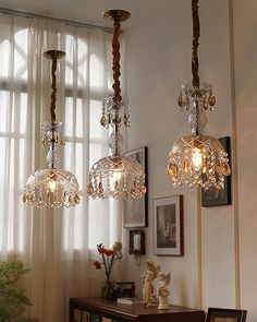 three chandeliers hanging from the ceiling in a living room