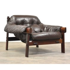 a brown leather reclining chair with wooden legs