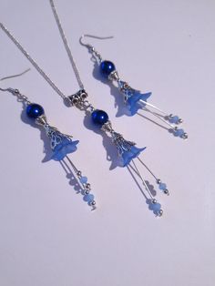 blue pearl Victorian Silver flower jewelry set cobalt blue flower set necklace earrings blue flower jewelry set blue  crystal Boho Silver set gift Gorgeous  Victorian style jewelry set necklace and earrings . Bohemian necklace and earrings . Beautiful Set of silver-tone Antique style ornaments and cobalt blue crystal pearls and blue plastic flowers with little fine blue crystals necklace and earrings. Silver-tone Victorian style necklace and earrings. Boho necklace. Bohemian necklace and earrings. Romantic necklace and earrings. Royal style jewelry set. Baroque style jewelry set. Antique style jewelry set. Gothic style jewelry set.  Perfect Gift for girlfriend,  mother,  sister,  bridesmaids or Maid of honor. Gift for special people or jewelry set for your special occasion. FREE SHIPPING Blue Sterling Silver Necklace With Flower Charm, Elegant Beaded Flower-shaped Jewelry, Elegant Blue Flower Charm Earrings, Nickel-free Blue Necklaces For Wedding, Blue Nickel-free Necklaces For Wedding, Sapphire Flower Jewelry For Gifts, Blue Sterling Silver Earrings With Flower Charm, Blue Flower Shaped Necklace Gift, Elegant Blue Flower Shaped Necklace