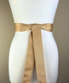 Narrow Ribbed Gold Sash Belt  Light Gold Dress Sash  Textured Gold Tie Belt  Narrow Gold Wedding Sash Belt  Pale Gold Sash  Make this Satin Swank® narrow waist sash the perfect finishing touch for your bridesmaid, wedding, or special occasion dress, or just the right piece to add instant polish to your dress or top. Depending on your waist size and the length you choose (60, 75, and 90 inch lengths available), you can wrap the sash around your waist once or twice. You decide whether to tie the sash in a bow or a simple knot with long-hanging tails. Tie in front, in back, or on the side. A double layer of mid-weight Bengaline satin fabric this sash features a lovely sheen and pronounced but fine ribs resulting in beautiful texture and depth. Sash is constructed in one long piece and is the Light Gold Dress, Gold Sash, Narrow Waist, Gold Tie, Wedding Sash Belt, Waist Sash, Dress Sash, Wedding Sash, Wedding Belts