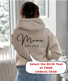 "Mama Sweatshirt, Mum Hoodie, Personalised Mother, Custom Mom Jumper, Mothers Day Gift, Mama Birthday Gift, Mother's Day Top, Mother Gifts, Hooded Sweatshirt, Maternity Gift for Mom, Mom to be Gift Looking for an original birth gift for the brand new mom or a cool Mother's Day gift for the \"experienced\" mom, this personalized hooded sweatshirt with birth year is the solution! 🇺🇸 MADE IN USA FREE SHIPPING USA Available in 5 different colors. This unisex heavy blend hooded sweatshirt is relaxa Birthday Long Sleeve Hoodie With Letter Print, Birthday Letter Print Long Sleeve Hoodie, Long Sleeve Hoodie With Letter Print For Birthday, Casual Cotton Hoodie For Birthday, Winter Birthday Hoodie With Letter Print, Hooded Letter Print Sweatshirt For Birthday, Hooded Sweatshirt With Letter Print For Birthday, Winter Birthday Sweatshirt With Letter Print, Winter Birthday Hooded Hoodie